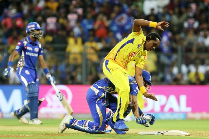 Hardik Panadya falls as he gets entangled with Dwayne Bravo while sliding to complete a run