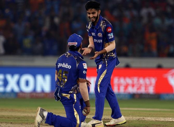 Mayank Markande celebrates with captain Rohti Sharma after taking the wicket