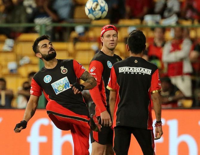 Virat Kohli, A B de Villiers and Yuzvendra Chahal play football ahead of an IPL game. Photograph: BCCI