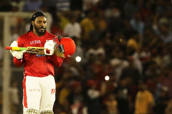 Chris Gayle gestures towards his family in the crowd as he celebrates his century