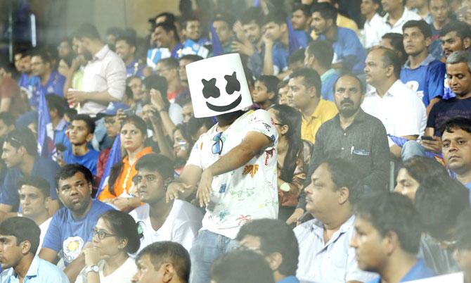 A fan sports a mask