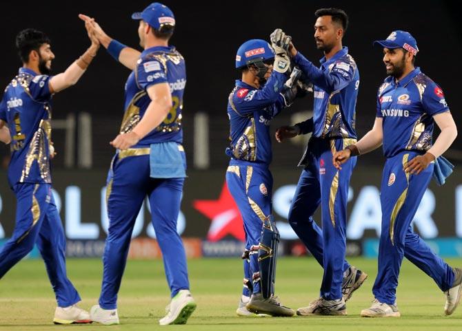 Mumbai Indians players celebrate the wicket of Shane Watson