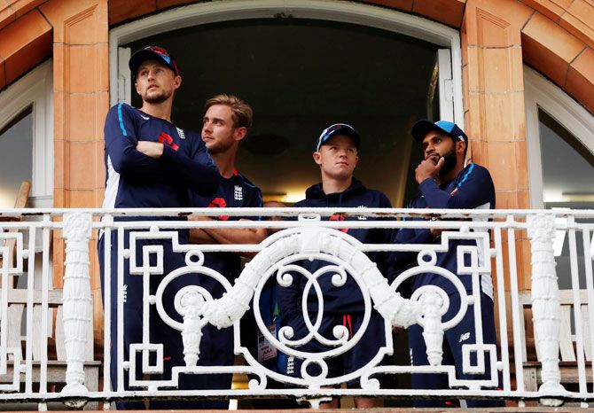 England's Joe Root, Stuart Broad, Adil Rashid and Ollie Pope on the players balcony during a rain delay on Thursday