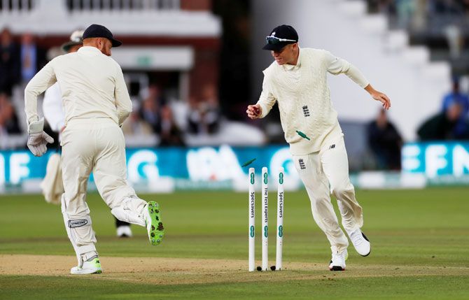 England's Ollie Pope removes the bail as he runs out India's Cheteshwar Pujara