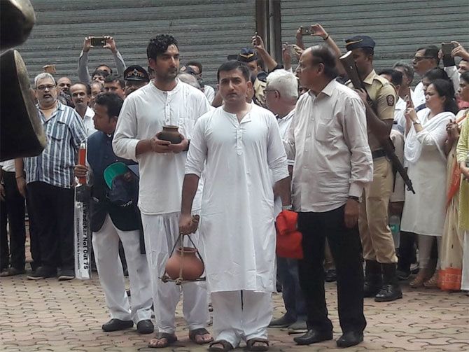The Wadekar family proceeds for the cremation ceremony