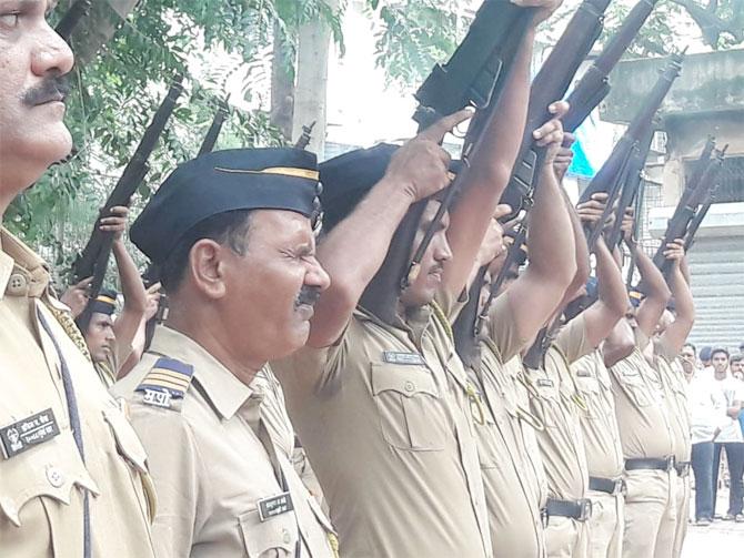 Policeman fire arms as the body of Ajit Wadekar is taken for cremation