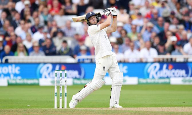 England's Jos Buttler hits a six