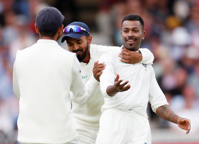 India's Hardik Pandya celebrates with teammates after taking the wicket of England's Stuart Broad