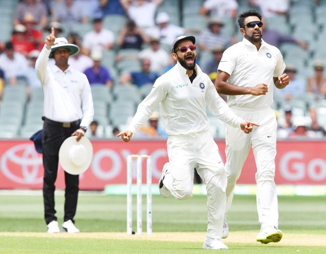India's captain Virat Kohli and his teammate Ravichandran Ashwin celebrate the dismissal of Australia's Marcus Harris on Day 2 of the first Test at the Adelaide Oval on Friday. Ashwin ended the day with figures of 3 for 50