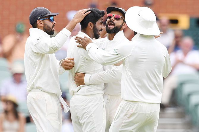 India's captain Virat Kohli (2nd right) celebrates with his Jasprit Bumrah (2nd from left) after the dismissal of Peter Handscomb