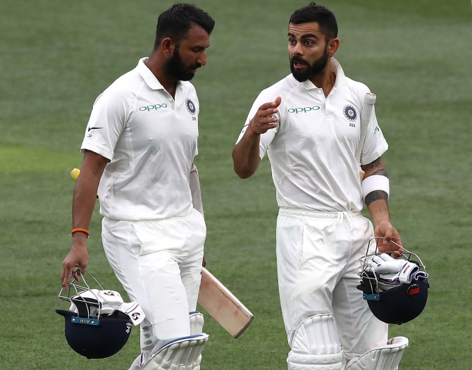 Virat Kohli speaks to Cheteshwar Pujara on Day 3 of the first Test against Australia at the Adelaide Oval, December 8, 2018.