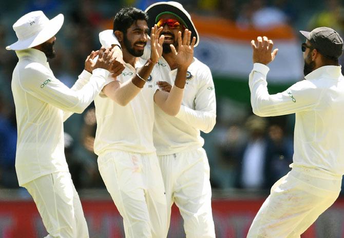 India's players celebrate the wicket of Shaun Marsh