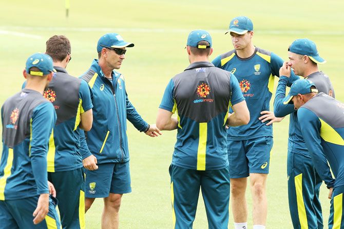 Australian cricket players chat with coach Justin Langer during a training session at the WACA in Perth on Wednesday