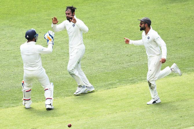 Hanuma Vihari celebrates with teammates after dismissing Marcus Harris in the 2nd Test in Perth