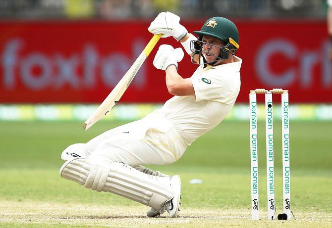 Marcus Harris is struck on the helmet by a ball from Jasprit Bumrah