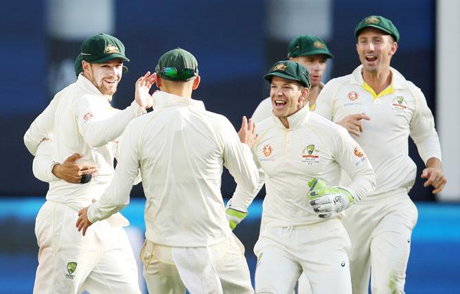 Travis Head celebrates with teammates after taking a catch to dismiss Ajinkya Rahane off Josh Hazlewood's bowling