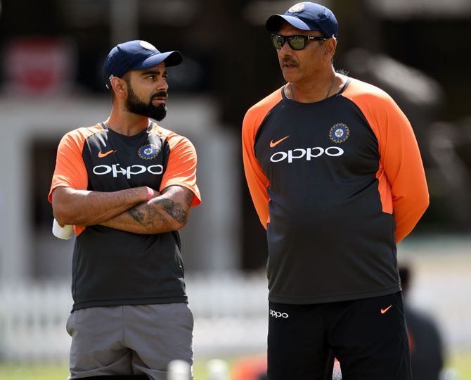 Virat Kohli and Ravi Shastri. 'For me to be part of that journey with the boys and for the boys to respond and raise the bar in that fashion leaves you going from the dressing room emotional but a very proud man.'