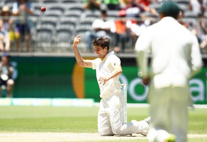 Australia's Pat Cummins takes a catch off his own bowling to dismiss India's Jasprit Bumrah