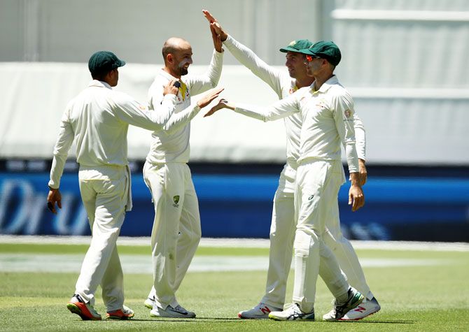 Australia's Nathan Lyon and Peter Handscomb celebrate after combining to take the wicket of Rishabh Pant