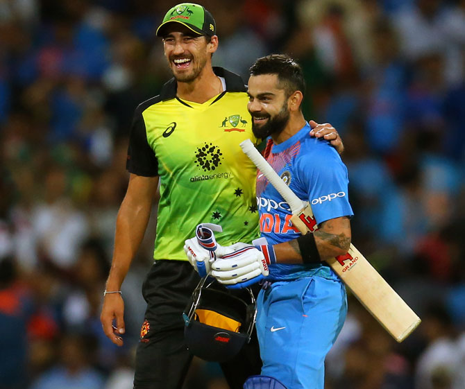 Mitchell Starc, left, with Virat Kohli