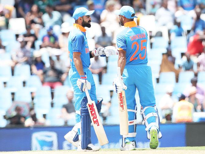 Virat Kohli and Shikhar Dhawan pump fists on completing a 50-run stand