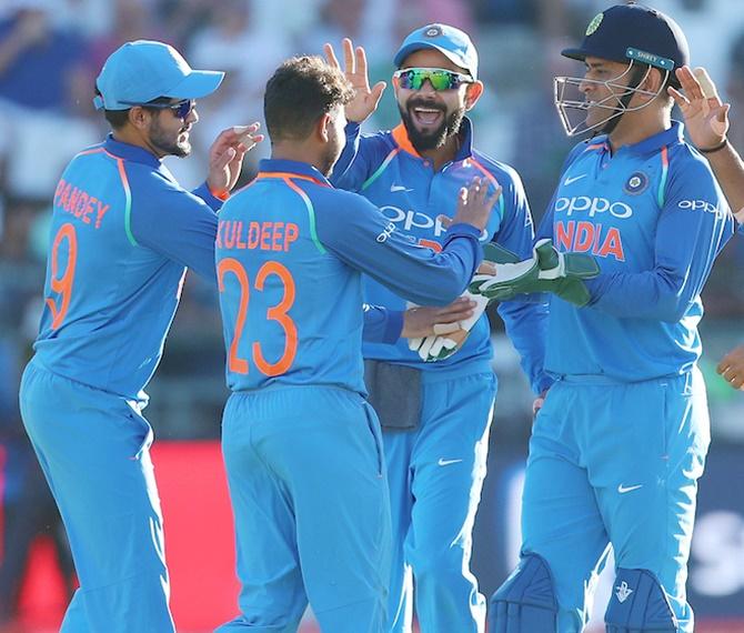  Kuldeep Yadav celebrates the wicket of Aiden Markram with Mahendra Singh Dhoni and teammates