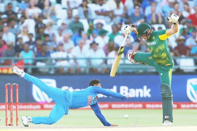 Kuldeep Yadav fields the ball off his own bowling