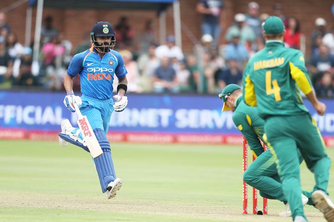 Virat Kohli watches as the bails are removed and he is run out