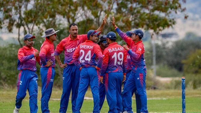 Nepal's players celebrate the fall of a wicket