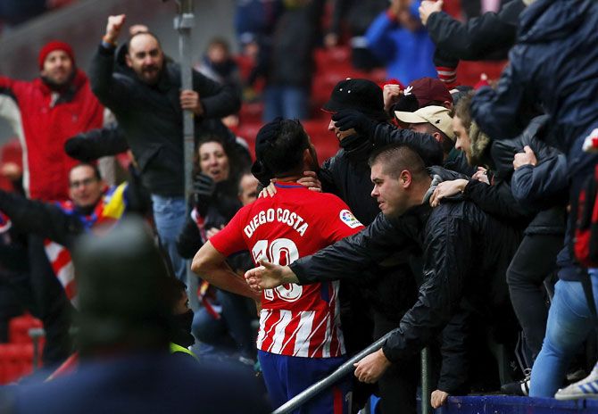 Atletico de Madrid's Diego Costa celebrates with fans after scoring their second goal during the La Liga match against Getafe CF at Estadio Wanda Metropolitano in Madrid on Saturday. His wild celebrations invited a booking