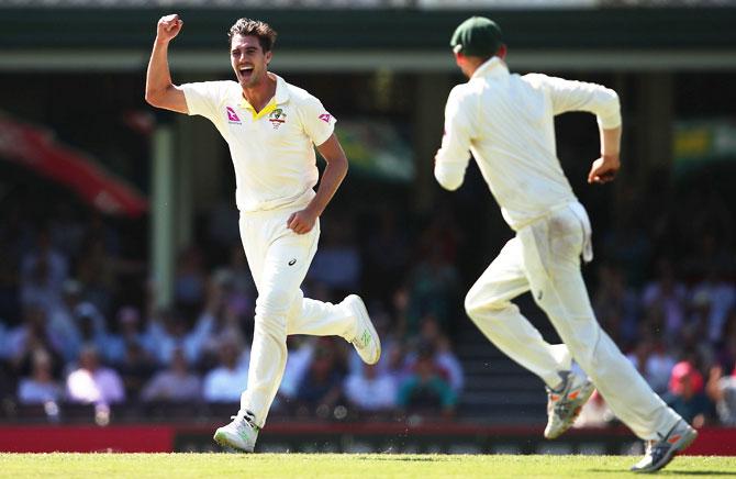 Australia's Pat Cummins celebrates after dismissing England's James Vince