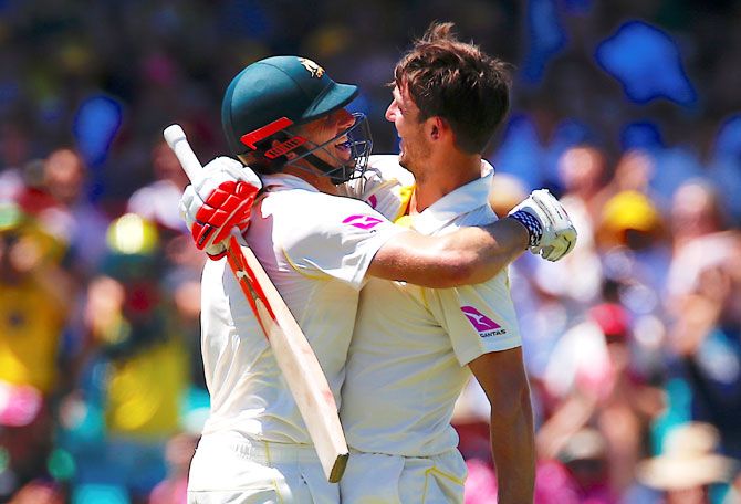Australia's Mitchell Marsh is hugged by his brother and teammate Shaun Marsh after reaching his century 