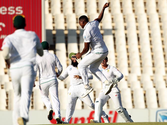 South Africa's Lungi Ngidi celebrates with teammates after taking the wicket of Virat Kohli