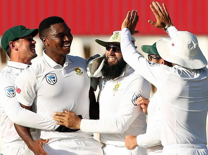South Africa's Lungi Ngidi celebrates with teammates after taking the wicket of Virat Kohli