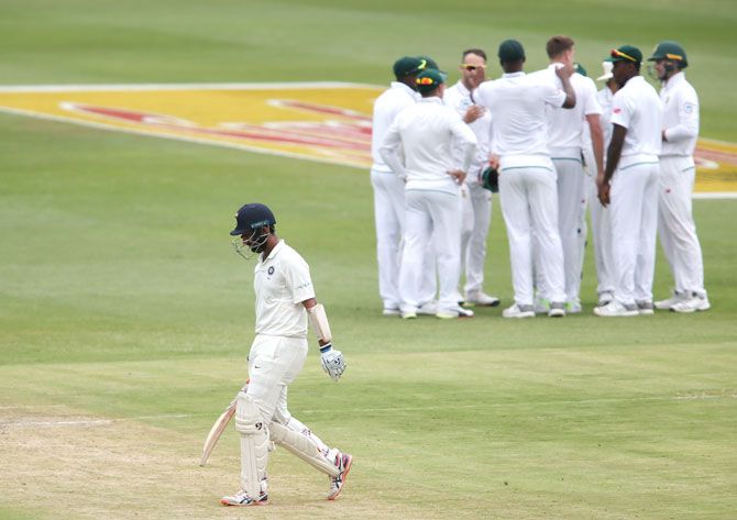 India's Cheteshwar Pujara leaves the field after his dismissal