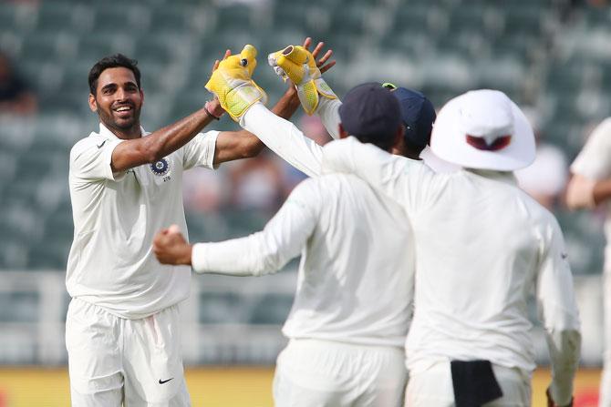 Bhuvneshwar Kumar is congratulated for picking the wicket of Kagiso Rabada