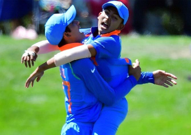  India captain Prithvi Shaw, right, celebrates the fall of a Pakistan wicket with his team-mate during their match on Tuesday