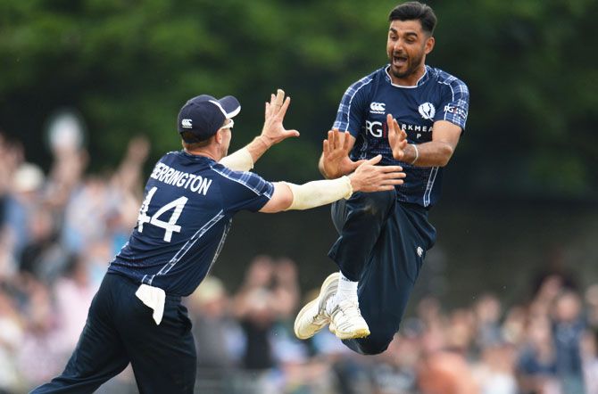 Scotland's Safyaan Sharif celebrates after taking the final wicket of England's Mark Wood to help  Scotland record a six-wicket win in their ODI match at Grange cricket club ground in Edinburgh, Scotland on Sunday