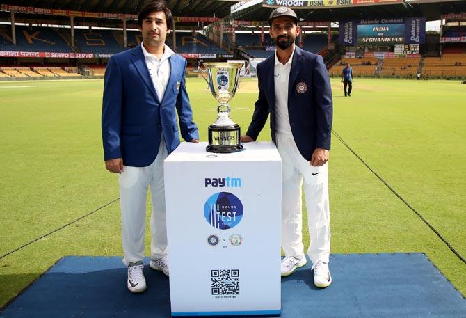 Captain Asghar Stanikzai with India skipper Ajinkya Rahane