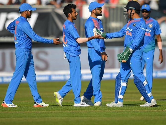 Yuzvendra Chahal celebrates with his team mates after taking the wicket of Andrew Balbirnie