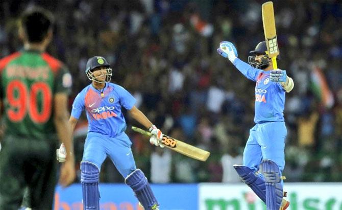 Dinesh Karthik celebrates with Washington Sundar after playing his match-winning six off the last ball