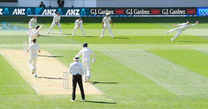 New Zealand captain Kane Williamson dives to take a catch and dismiss England batsman Stuart Broad off the bowling of Tim Southee