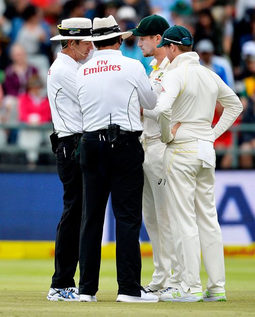 Cameron Bancroft and Steven Smith (capt) of Australia having a chat with the umpires on Day 3 of the 3rd Test in Cape Town on  March 24