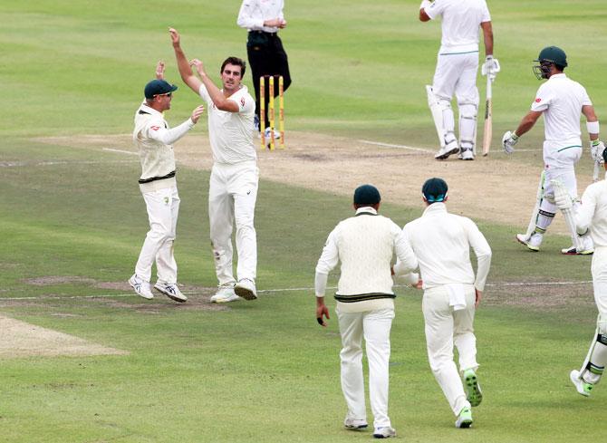 Australia's Pat Cummins and teammates celebrate the dismissal of South Africa's Dean Elgar