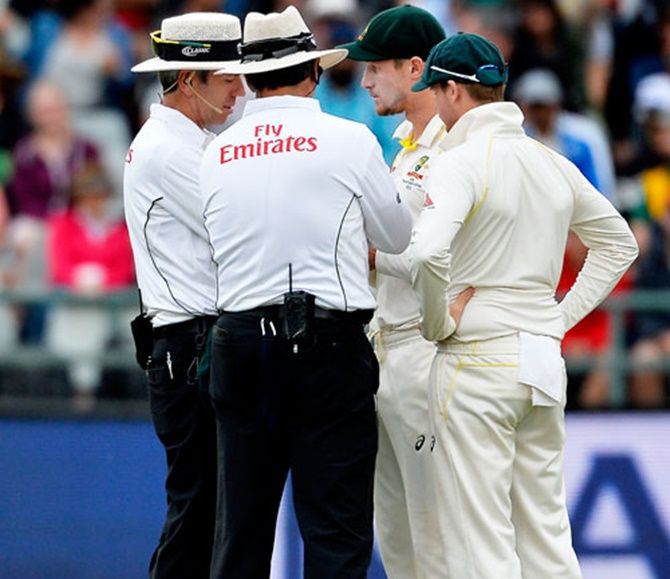 Australia's Cameron Bancroft and captain Steve Smith have a chat with the umpires on Day 3 of the 3rd Test in Cape Town after being caught for ball tampering. The duo, along with teammate David Warner were subsequently handed 12-month bans.