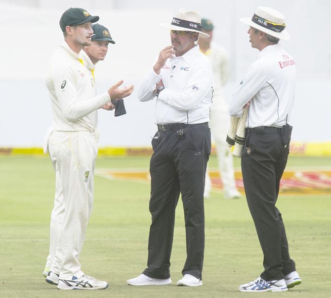 Umpires Nigel Llong and Richard Illingworth confront Australia's Cameron Bancroft on Day 3 of the third Sunfoil Test match against South Africa at PPC Newlands in Cape Town