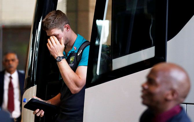 Australian cricketer Cameron Bancroft gestures as he arrives at a hotel in Sandton, South Africa on Tuesday