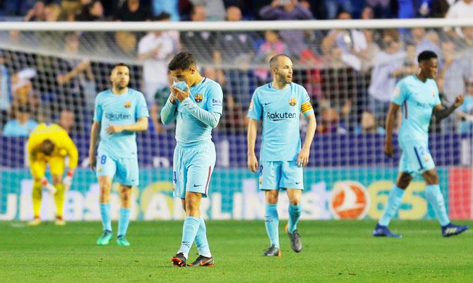 Barcelona's Philippe Coutinho and Andres Iniesta look dejected after Levante's Emmanuel Boateng scores their second goal during their La Liga match at Ciutat de Valencia in Valencia on Sunday