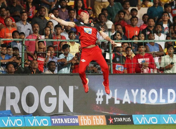 Royal Challengers Bangalore's A B de Villiers leaps, stretches out his right hand and plucks the balls swirling away from him, just above the boundary line, to complete the catch to dismiss Sunrisers Hyderabad’s Alex Hales
