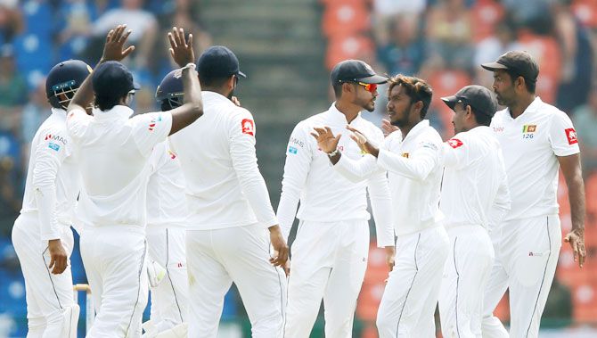 Sri Lanka's Akila Dananjaya celebrates with his teammates after taking the wicket of England's Rory Burns (not pictured) during the 2nd Test in Pallekele in Sri Lanka on Wednesday